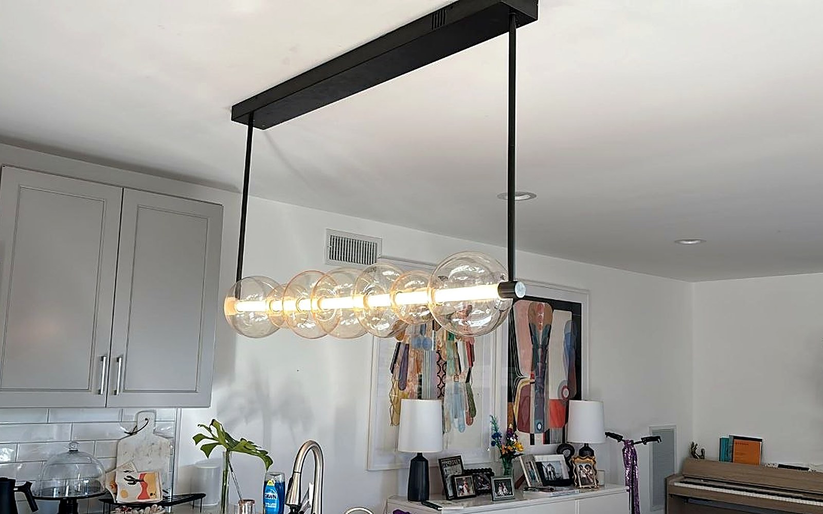 Linear pendant light fixture installed over a kitchen island